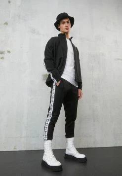 MOSCHINO TROUSERS - Trousers - Black